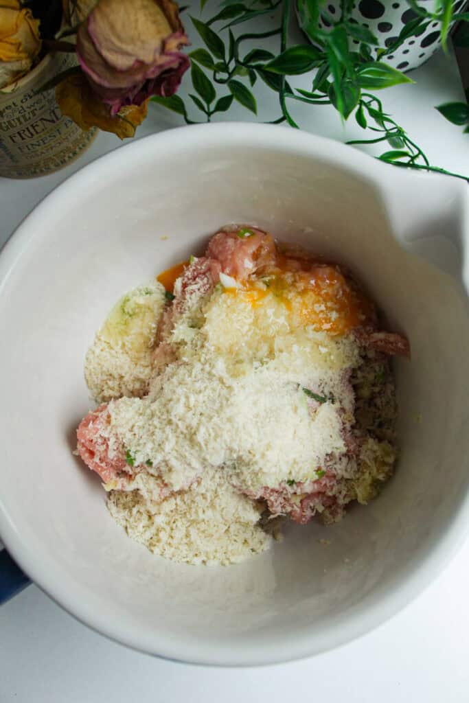 Sweet and sour chicken meatball ingredients in a mixing bowl.