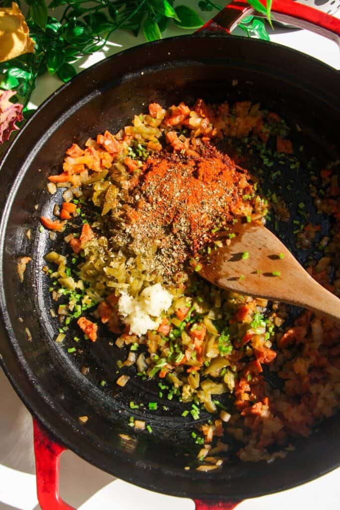 Onions, jalapenos and spices cooking in a pan.