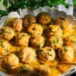 Chicken piccata meatballs in a white scalloped bowl.