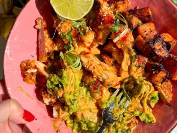 Chicken, sweet potato, whipped cottage cheese and avocado in a pink bowl.