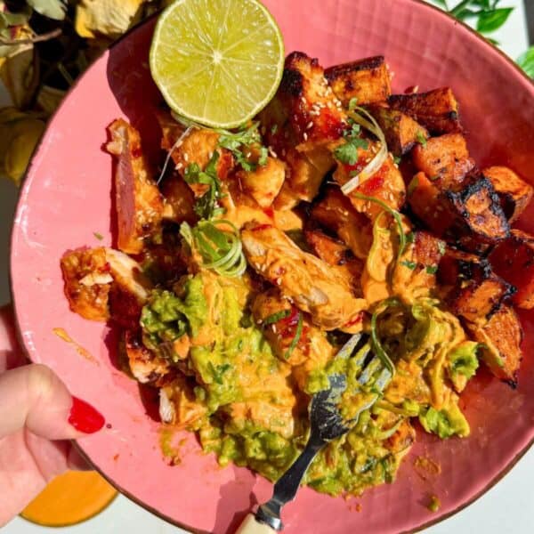 Chicken, sweet potato, whipped cottage cheese and avocado in a pink bowl.