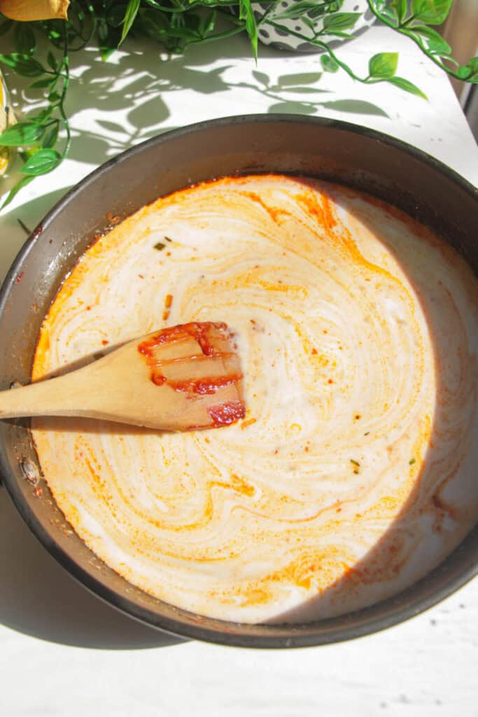 Coconut milk added to pan with gochujang paste.