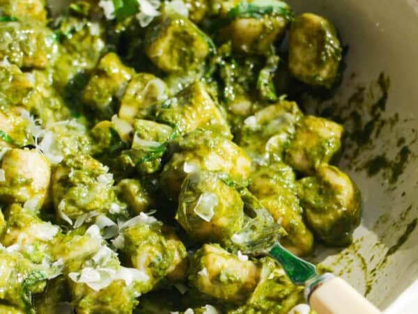 Cottage cheese gnocchi tossed with a green goddess sauce in a white bowl.