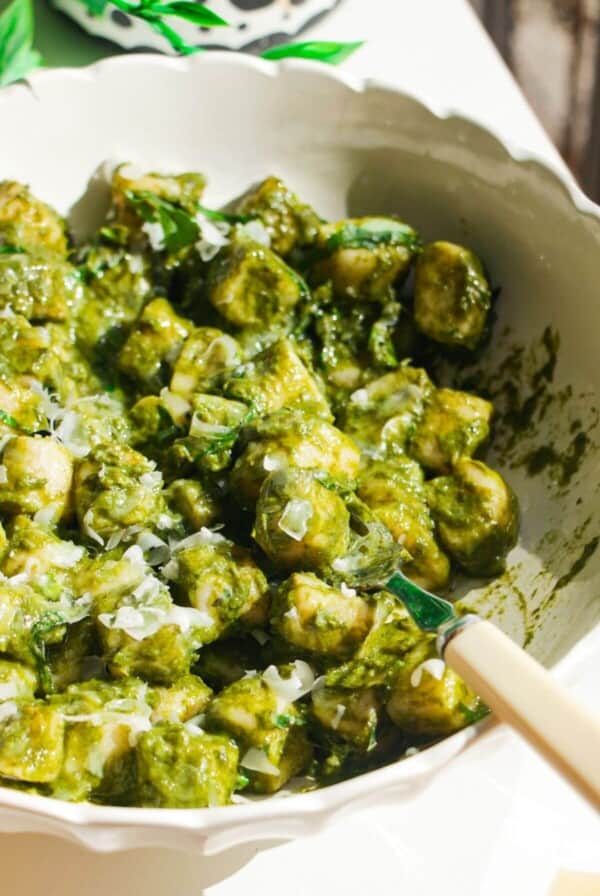 Cottage cheese gnocchi tossed with a green goddess sauce in a white bowl.