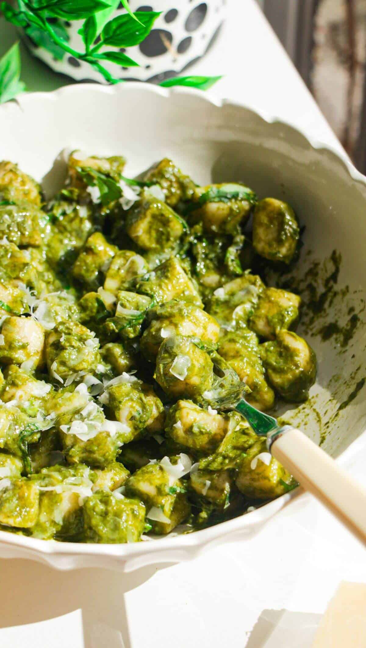 Cottage cheese gnocchi tossed with a green goddess sauce in a white bowl.
