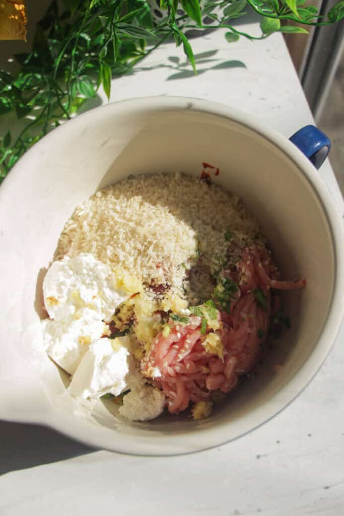Ingredients for gochujang meatballs in a mixing bowl.