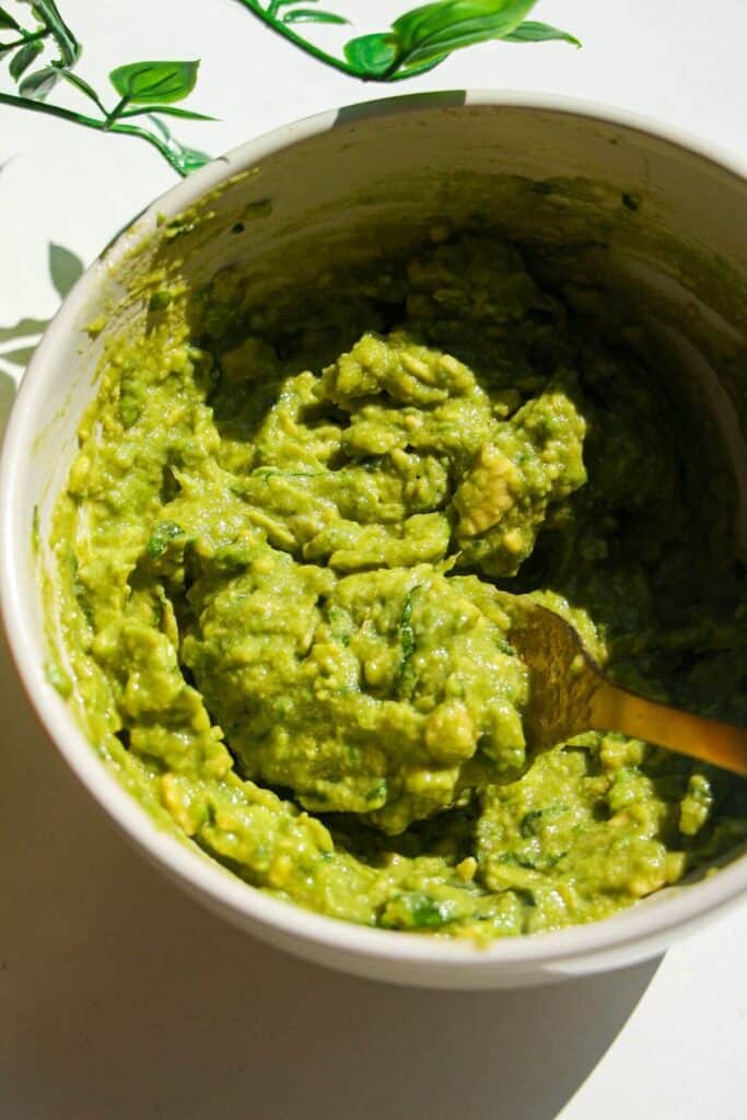 Whipped avocado in a small white bowl.