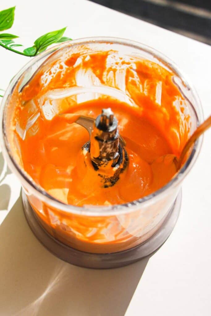 Whipped gochujang cottage cheese in a small blender.