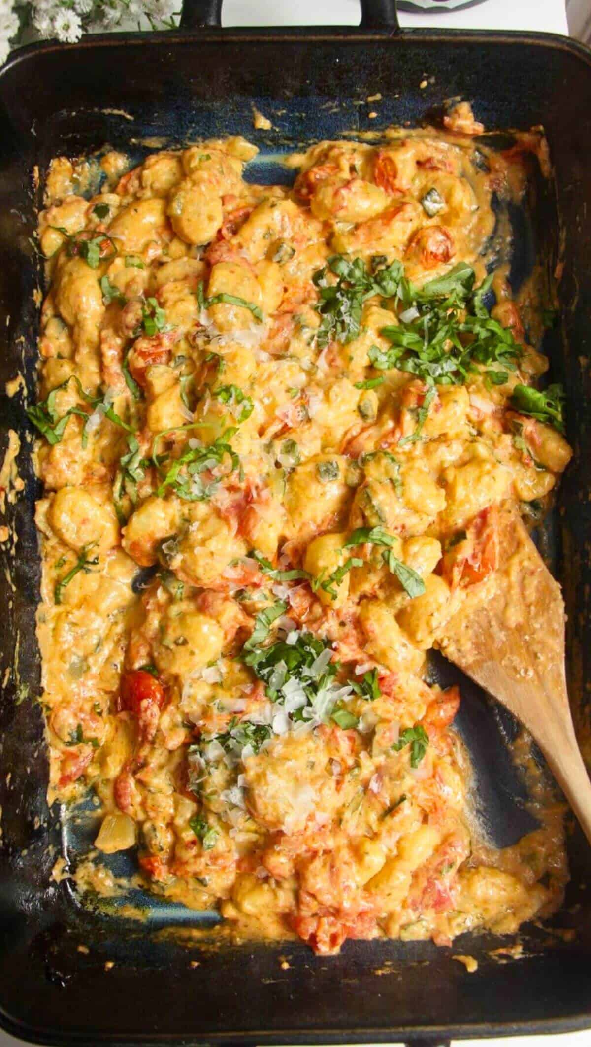 Baked cheesy tomatoey Boursin gnocchi in an oven tray.