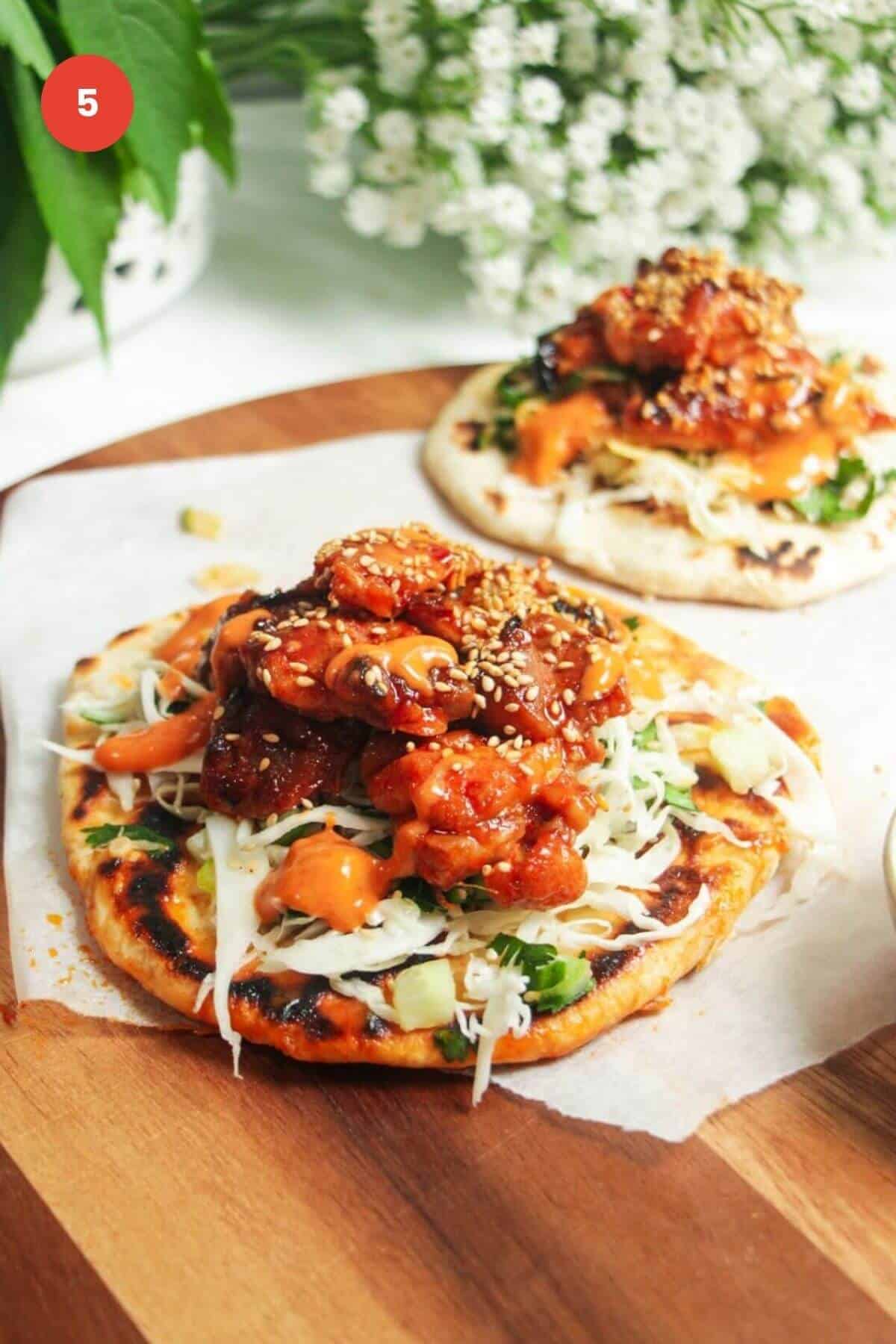 Sticky gochujang chicken on a flatbread.