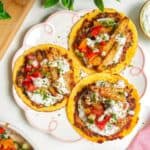 Three smash chicken gyros tacos on a small serving plate.