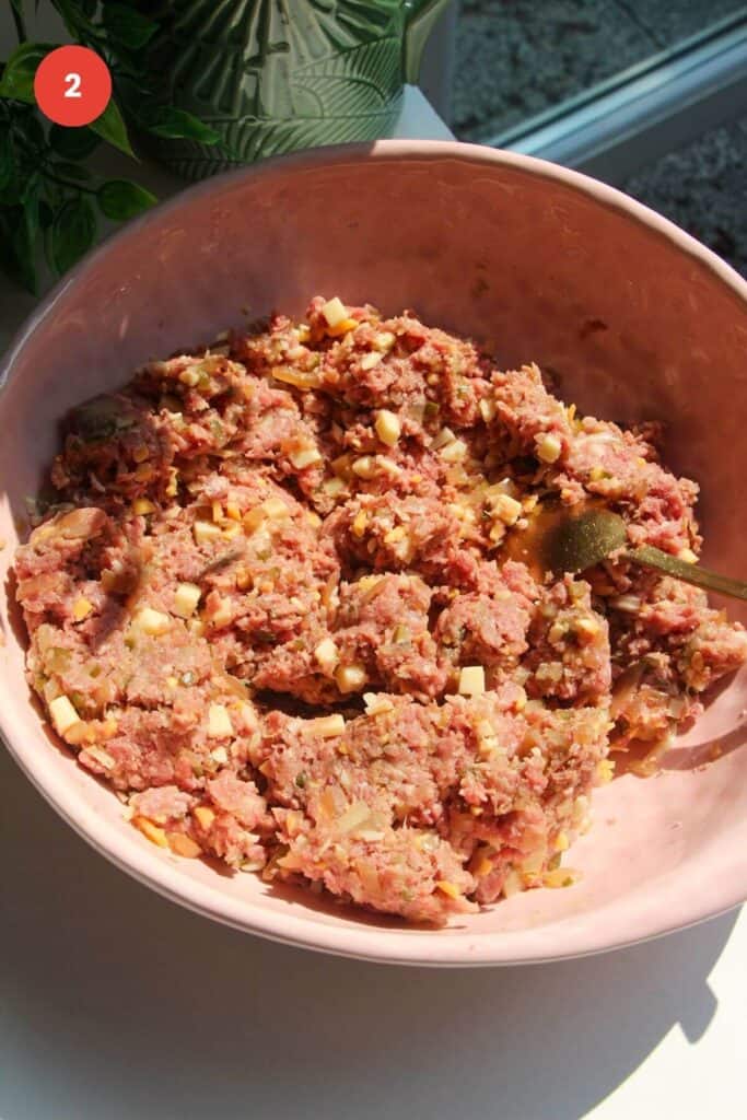 Cheeseburger meatball mixture combined in a large mixing bowl.