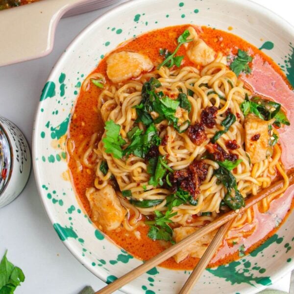 Saucy satay ramen in a bowl, with chopsticks.