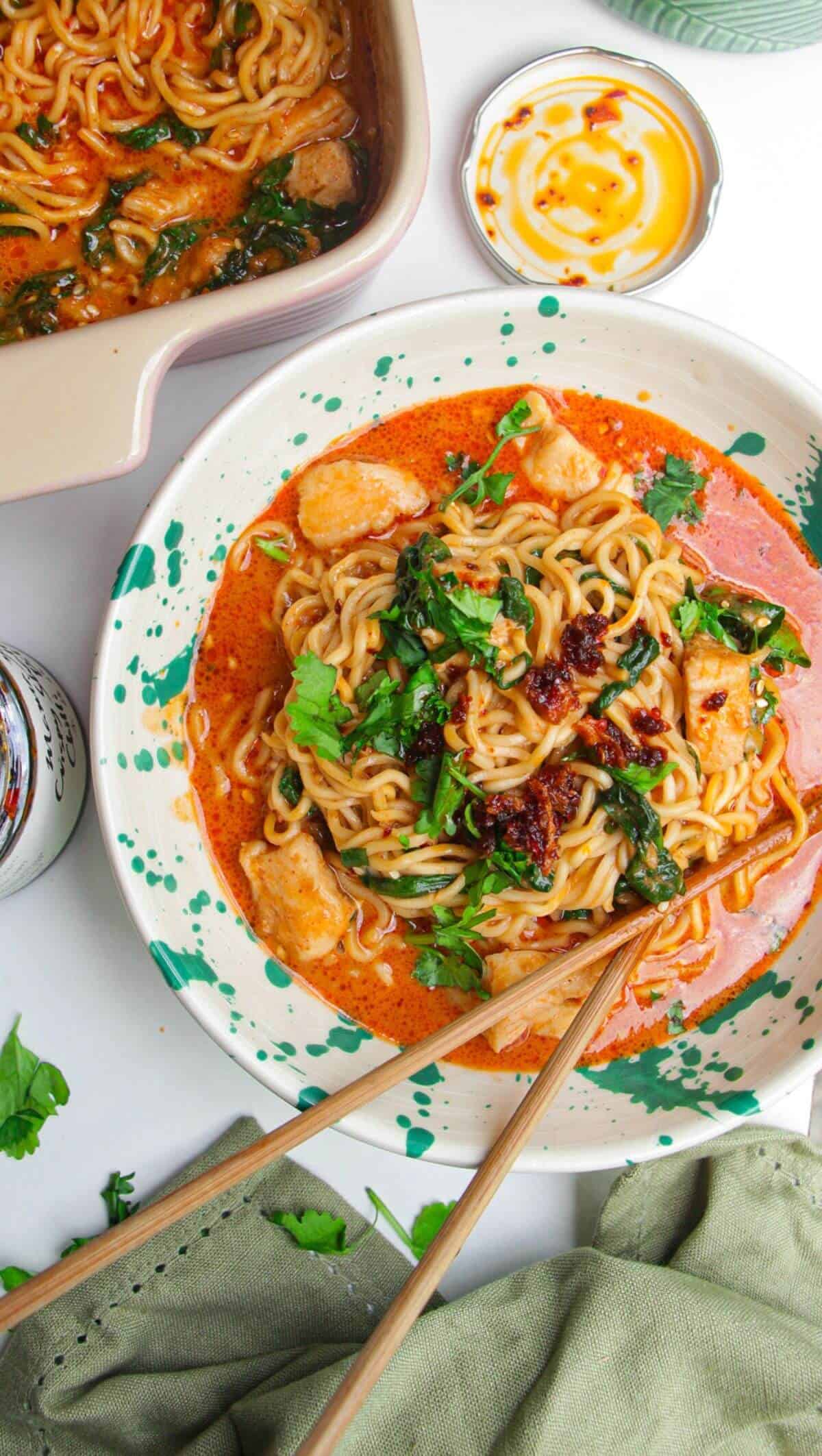 Saucy satay ramen in a bowl, with chopsticks.