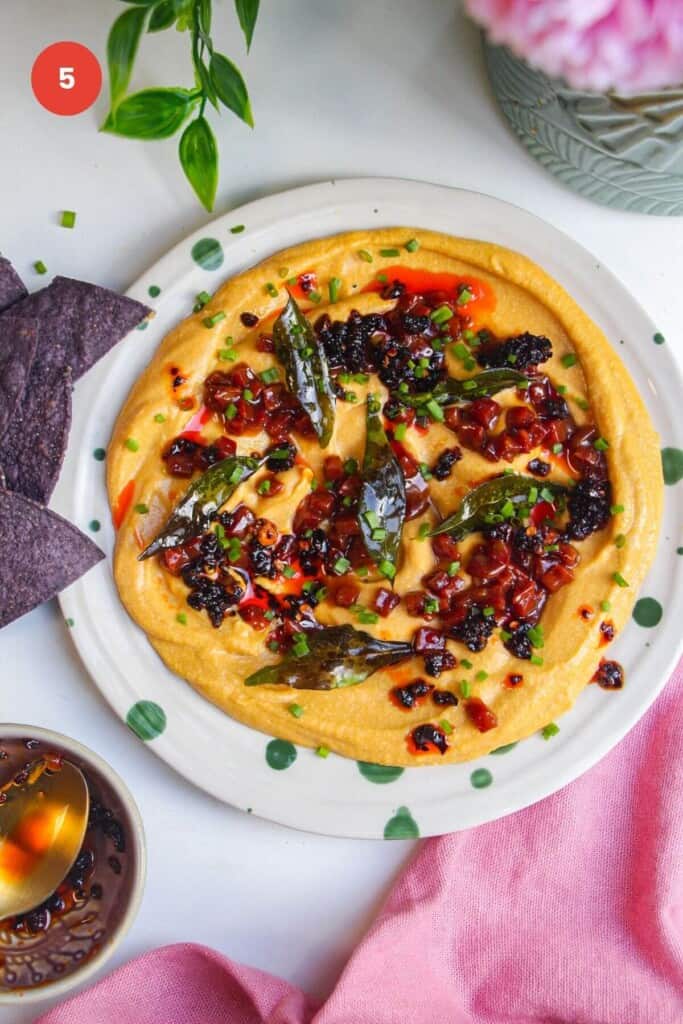 Butternut squash feta dip topped with chorizo, chili crisp and curry leaves.