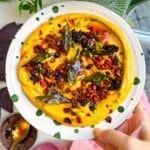 Butternut squash feta dip topped with chorizo, chili crisp and curry leaves.