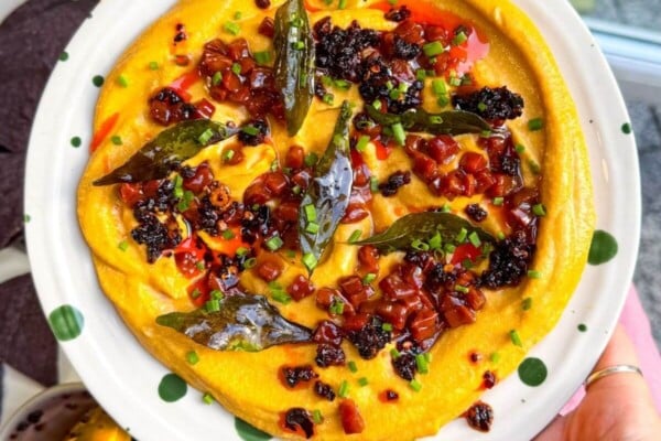 Butternut squash feta dip topped with chorizo, chili crisp and curry leaves.