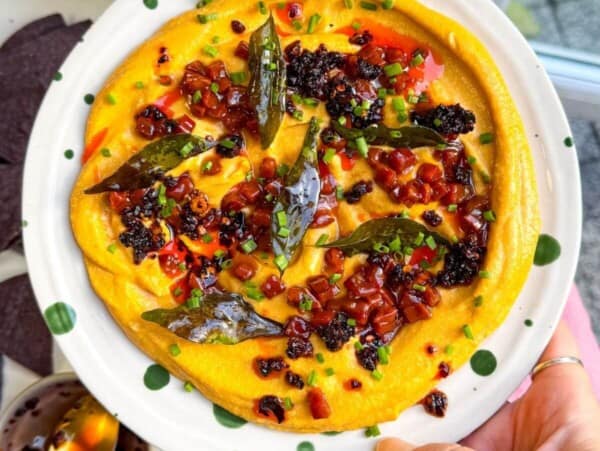 Butternut squash feta dip topped with chorizo, chili crisp and curry leaves.