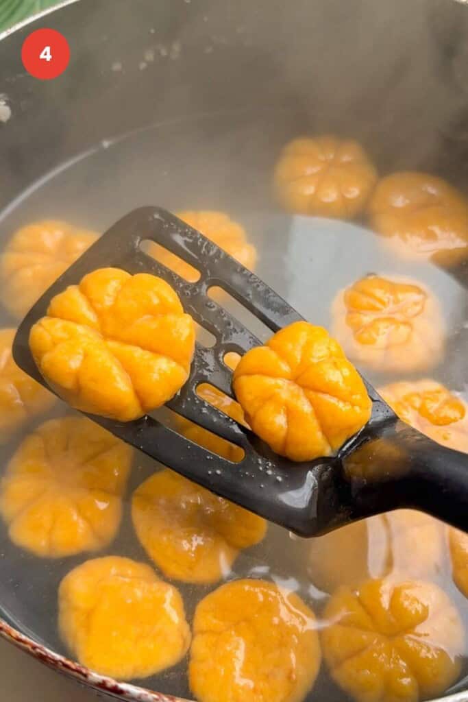 Spatula with two pumpkin shaped gnocchi.