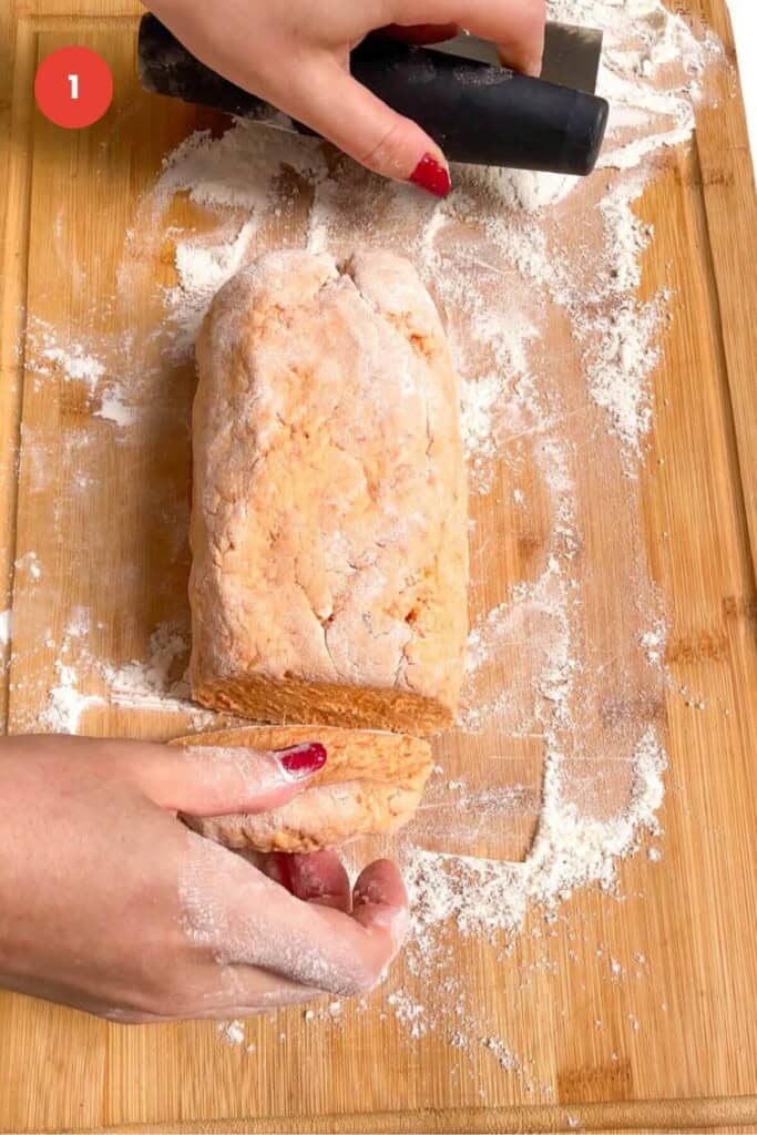 Gnocchi dough cut on wooden board.