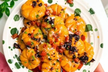 Holding plate of pumpkin shaped gnocchi.