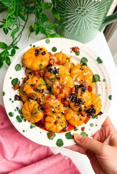 Holding plate of pumpkin shaped gnocchi.