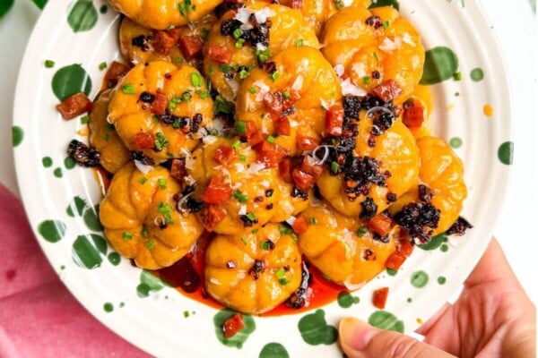 Holding plate of pumpkin shaped gnocchi.