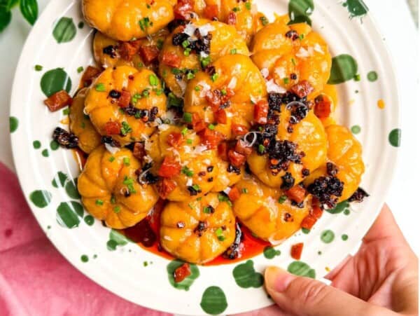 Holding plate of pumpkin shaped gnocchi.