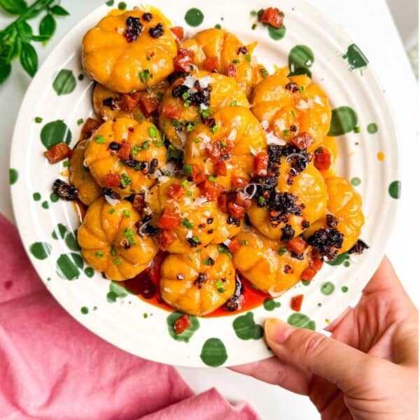 Holding plate of pumpkin shaped gnocchi.