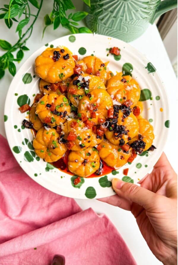Holding plate of pumpkin shaped gnocchi.