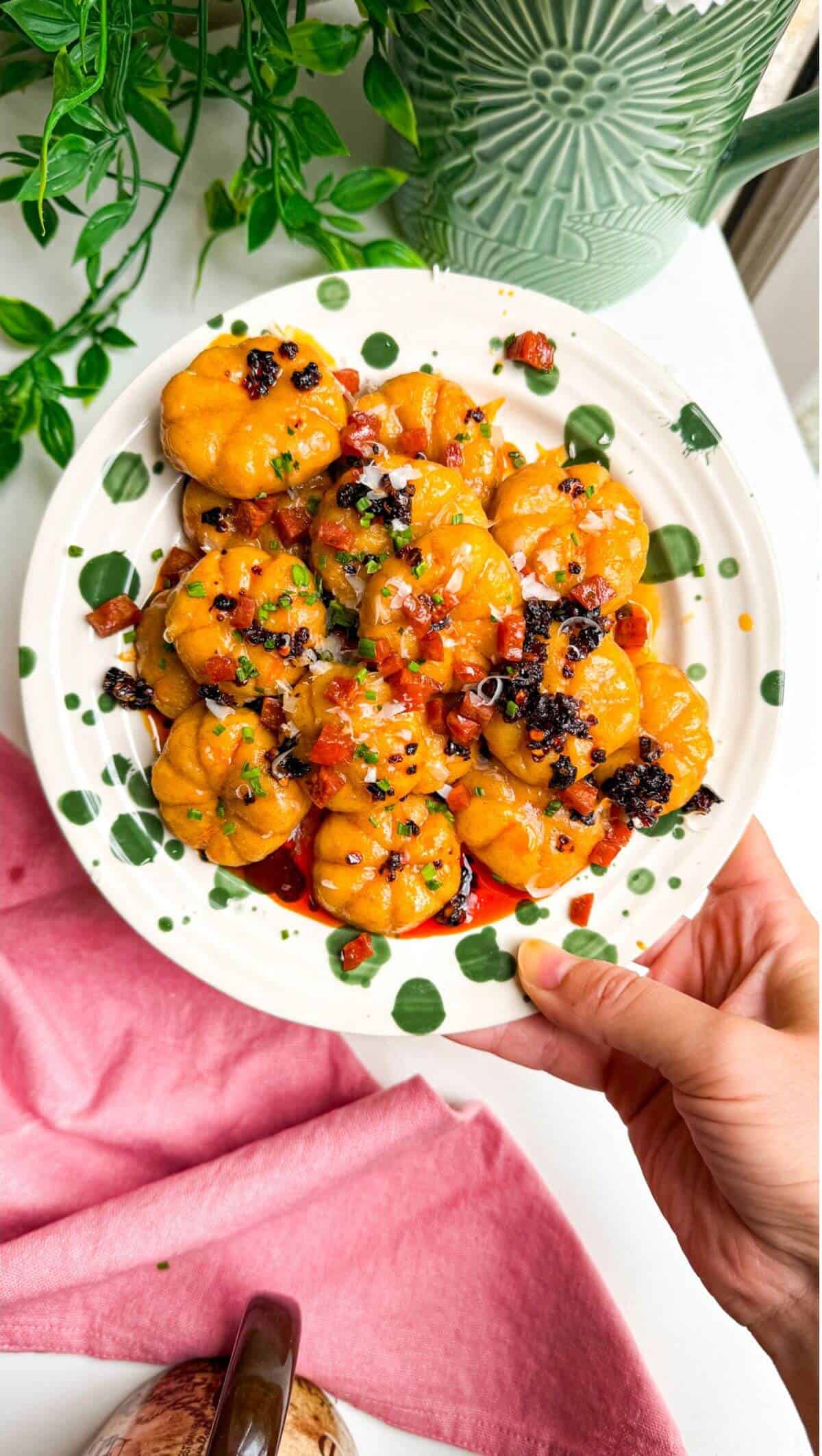 Holding plate of pumpkin shaped gnocchi.