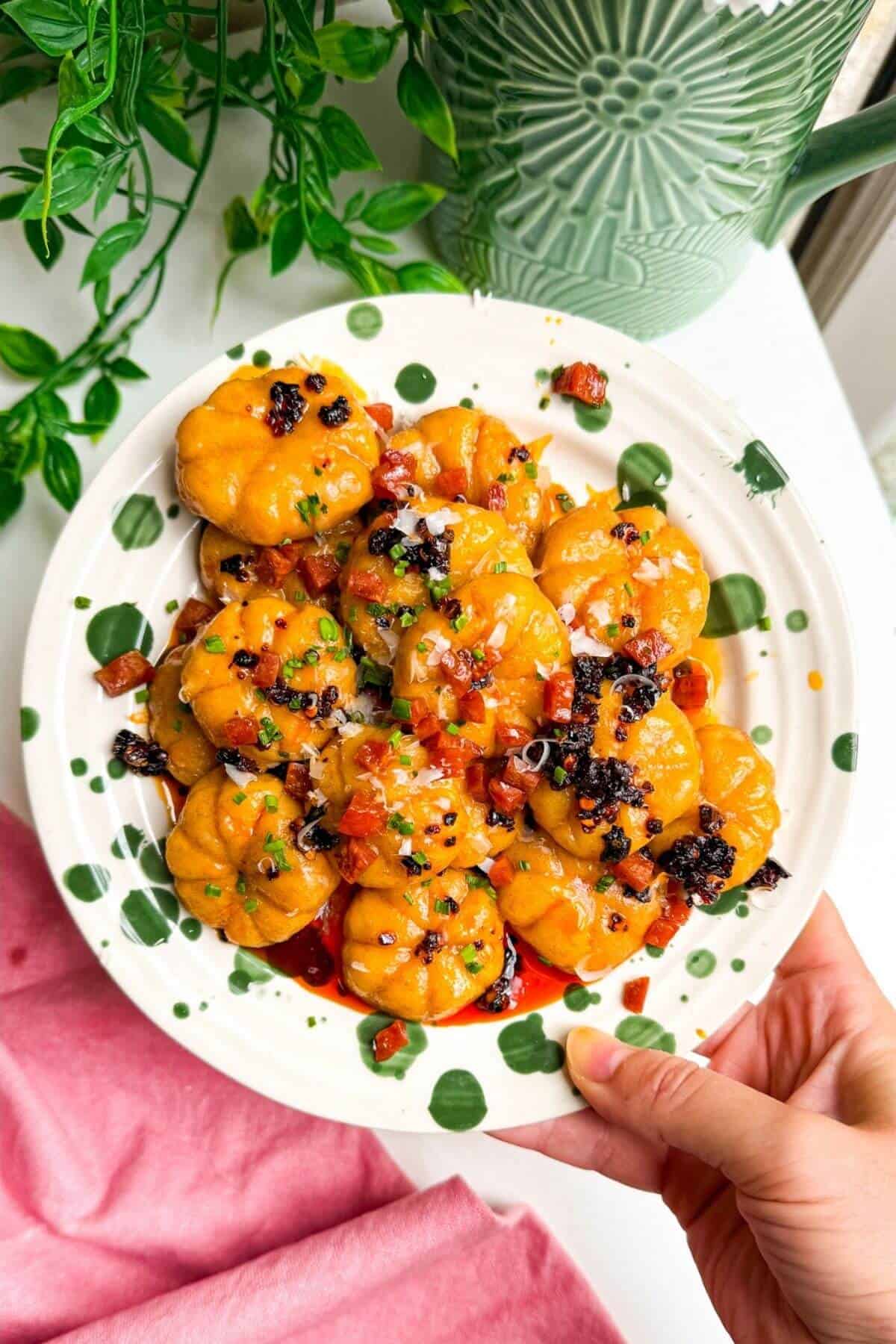 Holding plate of pumpkin shaped gnocchi.