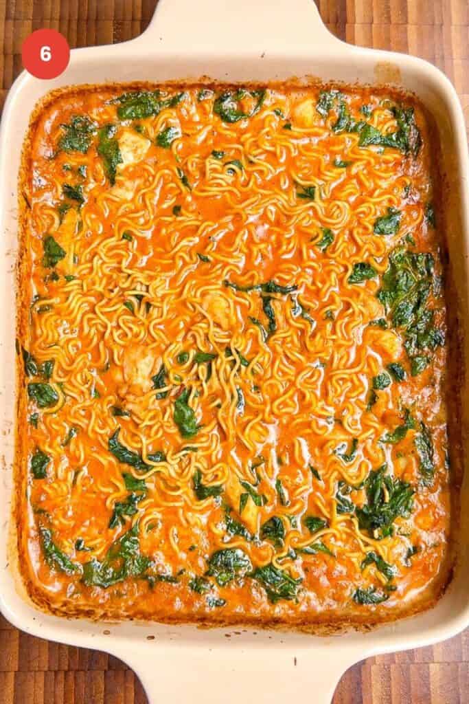 Baked satay ramen in an oven dish.
