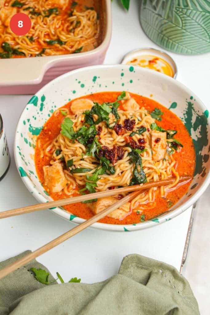 Saucy satay ramen in a bowl, with chopsticks.