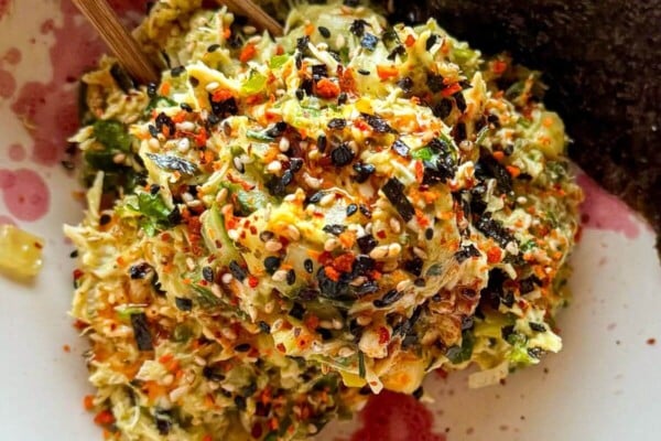 Chicken salad in a bowl with nori sheets on the side.