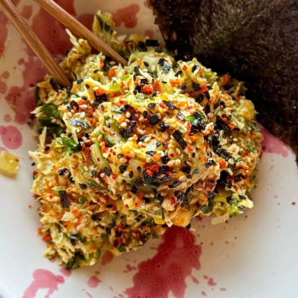 Chicken salad in a bowl with nori sheets on the side.