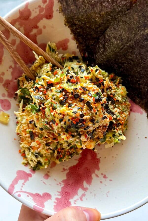 Chicken salad in a bowl with nori sheets on the side.