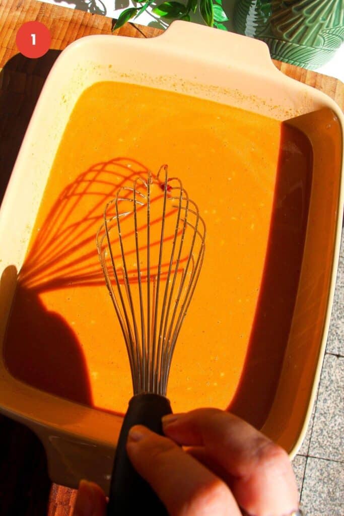 Whisking satay peanut sauce in an oven dish.