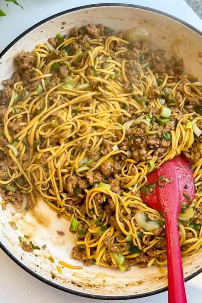 Noodles tossed through ground chicken and aromatics.