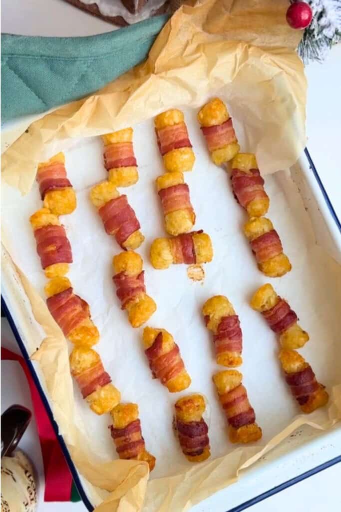 Baked bacon wrapped tots in oven tray.