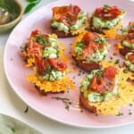 Herby ricotta cheesy crostini on a serving platter.