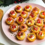 Smoked salmon hash brown cups on a platter with everything bagel seasoning on the side.