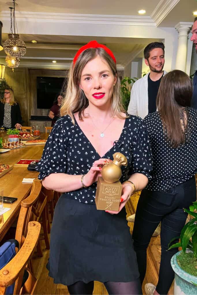 Kate holding Mutti award.