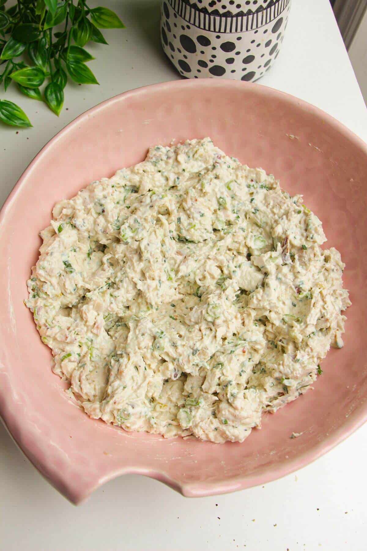 Caesar inspired chicken salad mixed in a large bowl.