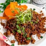 Holding sticky gochujang rice bowl.