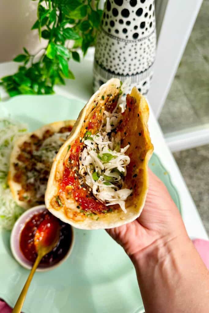 Holding sweet chili chicken taco.