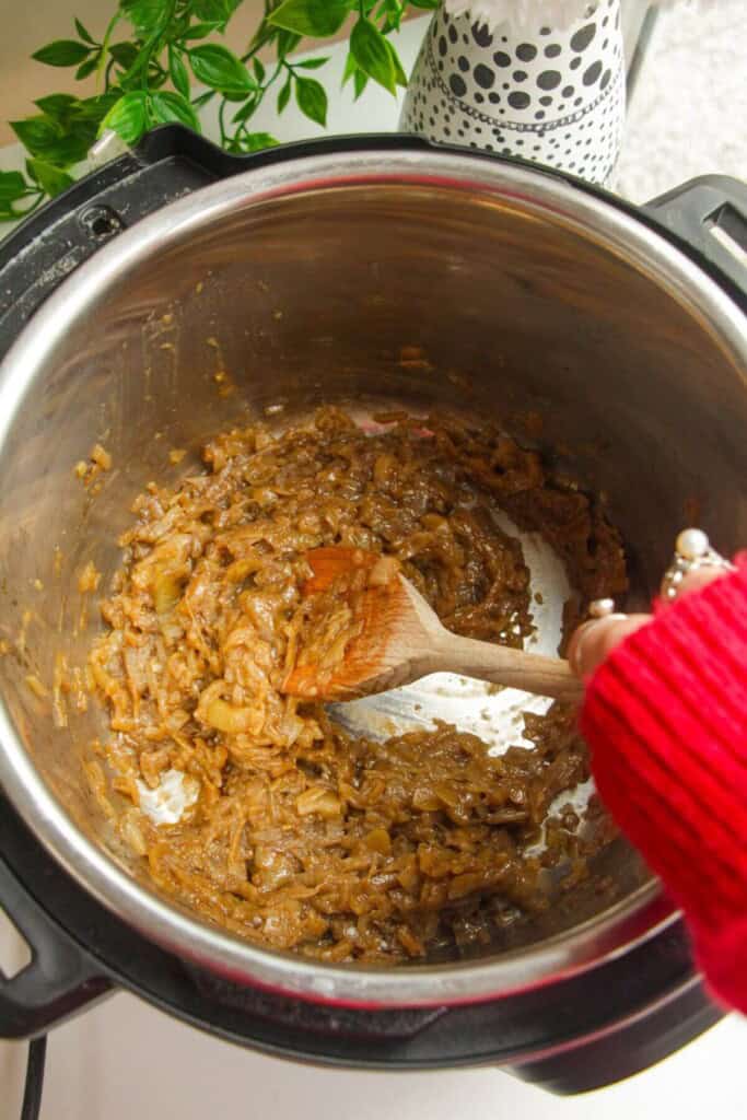 Stirring caramelized onions in an Instant Pot.