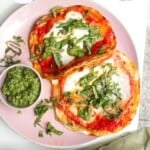 Chicken parm tacos on a platter with basil pesto.