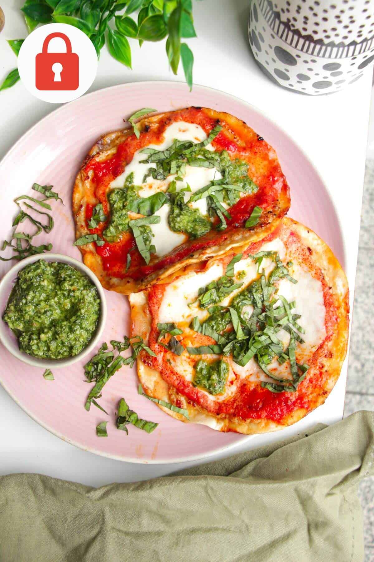 Chicken parm tacos on a platter with basil pesto.
