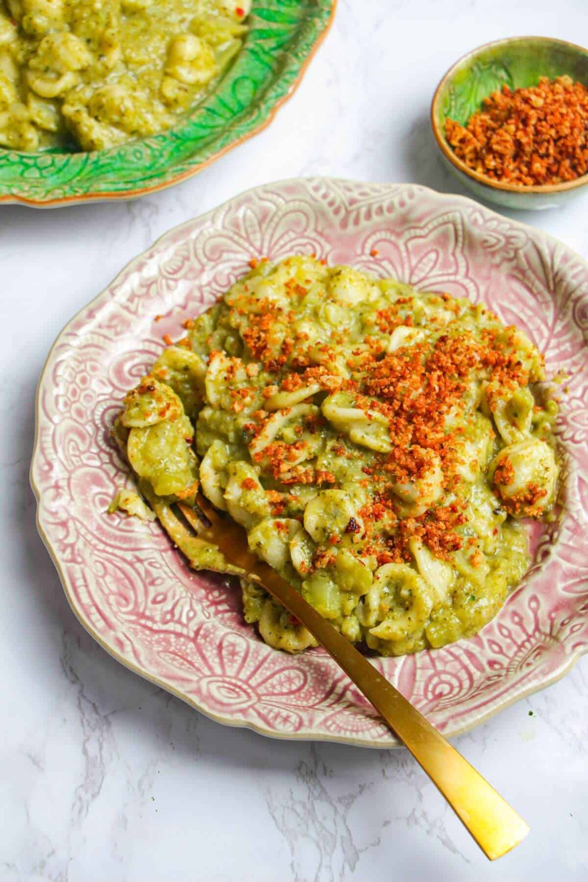 Broccoli pasta topped with golden pangrattato on a plate.